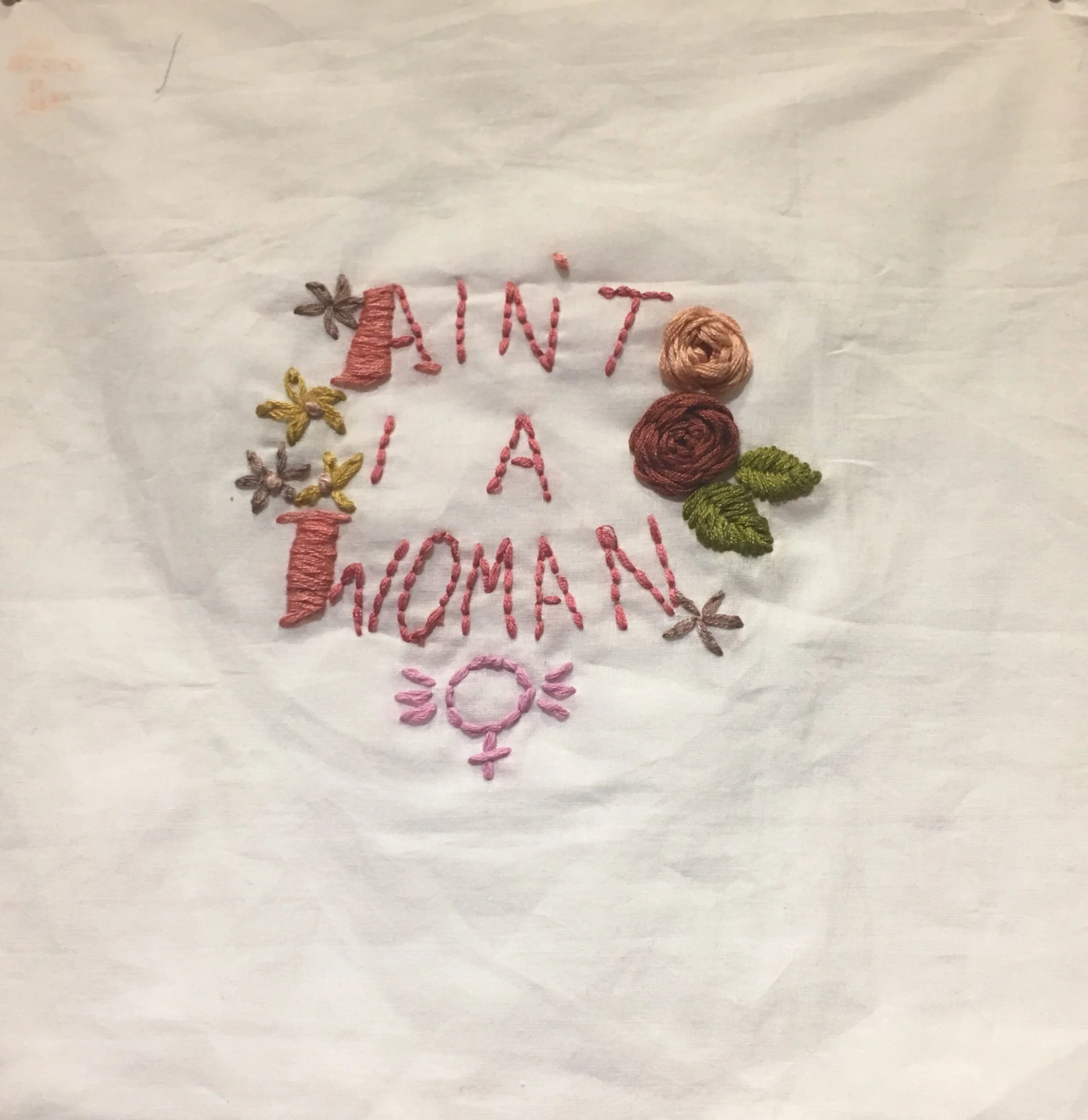 Embroidery with flowers and the text 