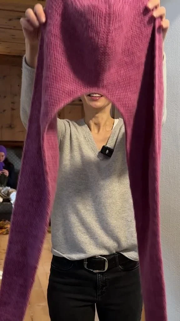 Cross-country skier and biathlete Lucinda Anderson holding up her knitting project at the Winter Olympics