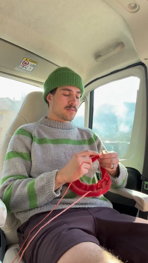 Olympic biathlete Adam Runnalls working on a knitting project, demonstrating the same precision and focus he brings to competitive sports.