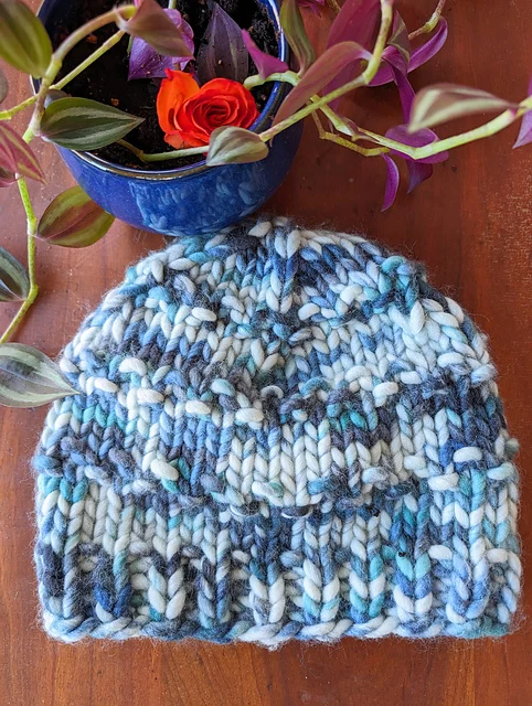 Ski Lift Hat by Hook Mountain Handmade, a textured knitted beanie in blue tones.